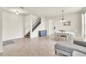 Open-concept living room with tiled floors, staircase, and natural light creating a welcoming atmosphere at 11754 Barletta Dr, Orlando, FL 32827