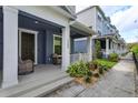 Charming covered front porch with stylish outdoor seating and lovely landscaping at 1304 Spotted Sandpiper Loop, Winter Springs, FL 32708