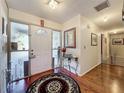 Inviting foyer with hardwood floors, decorative rug, and natural light at 1617 E Sandpiper Trl, Casselberry, FL 32707