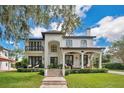 Stunning two-story home with manicured lawn, covered front porch, balcony, and elegant design at 1840 W Fawsett Rd, Winter Park, FL 32789