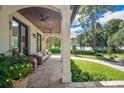 Inviting covered porch featuring comfortable seating, ceiling fans, and beautiful lake views at 1840 W Fawsett Rd, Winter Park, FL 32789