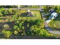 Extensive aerial shot of a secluded property enveloped by verdant trees and a manicured lawn at 19301 Wembley Ave, Orlando, FL 32833