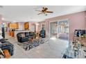 Open-concept living room with tile floors, ceiling fan, and sliding glass doors to the outdoor patio at 2509 Chapala Dr, Kissimmee, FL 34746