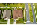 Overhead view of a home with a fenced backyard and nice landscaping, plus a long driveway at 2601 Gold Dust Cir, Kissimmee, FL 34744