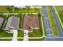 Aerial view of the house showing roof, lawn, and community streets at 2601 Gold Dust Cir, Kissimmee, FL 34744