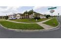 Landscaped corner lot featuring a well-kept lawn, mature trees, and attractive curb appeal at 2601 Gold Dust Cir, Kissimmee, FL 34744