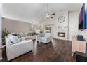 Bright living room with hardwood floors, fireplace, ceiling fan, and comfortable seating at 3043 Autumn Run Ct, Orlando, FL 32822