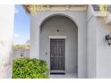 Welcoming front entrance featuring an arched entryway and a dark-colored front door at 3179 Turret Dr, Kissimmee, FL 34743