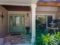 Inviting front entrance with a stone pathway, decorative fountain, and a charming sage-green door at 3431 Dawn Ct, Lake Mary, FL 32746