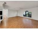 Spacious living room boasting hardwood floors, neutral paint, and natural light at 5030 Creekview Ln, Lakeland, FL 33811