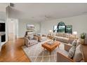 Bright living room featuring hardwood floors, lots of seating, and a large window with views of the outdoors at 5030 Creekview Ln, Lakeland, FL 33811