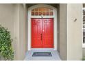 Inviting double front doors with a decorative transom window above at 600 Statenville Ct, Ocoee, FL 34761