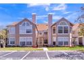 Exterior view of the residences, featuring reserved parking and well-maintained landscaping at 645 Stafford Ter # 162, Altamonte Springs, FL 32714