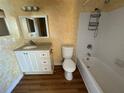 Bathroom featuring a modern vanity, framed mirror, a standard toilet, and a tiled shower-tub combination at 7309 Daniel Webster Dr # D, Winter Park, FL 32792