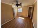 Bedroom featuring wood floors, neutral walls, and a ceiling fan providing a serene living space at 7309 Daniel Webster Dr # D, Winter Park, FL 32792