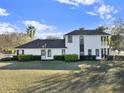 A side view of the house with a well manicured backyard and a covered balcony area at 7548 Gathering Dr, Reunion, FL 34747