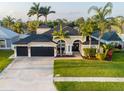 Aerial view of a charming home with a three-car garage, manicured lawn, and palm trees in a quiet neighborhood at 814 Chamberlin Trl, St Cloud, FL 34772