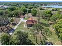 Aerial view highlighting the home, large yard, outbuilding and proximity to a lake at 9272 Gotha Rd, Windermere, FL 34786