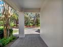 A view from the covered portico, showcasing the brick paver walkway at 10148 Chiltern Garden Dr, Orlando, FL 32827
