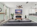 Open-concept living space with a modern fireplace, stylish decor, and neutral color palette at 11844 Pulitzer Pl, Orlando, FL 32832