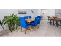 Dining area featuring a wooden table, elegant blue chairs, and stylish decor with natural light at 1399 Lassen St, Haines City, FL 33844