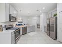 Modern kitchen featuring stainless steel appliances, ample countertop space, and white cabinetry at 1399 Lassen St, Haines City, FL 33844