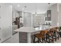Bright kitchen showcasing a spacious island with bar seating, modern countertops and stainless appliances at 1399 Lassen St, Haines City, FL 33844