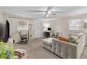 Bright living room with a ceiling fan, comfortable seating and plenty of natural light at 1401 E Voorhis Ave, Deland, FL 32724