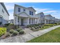 Inviting two-story home featuring a well-manicured lawn and a cozy front porch in a pleasant neighborhood at 14317 Lanikai Beach Dr, Orlando, FL 32827