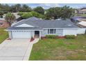 Inviting home features a two-car garage and a well-kept lawn, as well as charming stone accents at 1484 Patricia St, Kissimmee, FL 34744