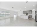 Bright, open-concept living and kitchen area with tile flooring and abundant natural light at 1533 Peach Creek Dr, Osteen, FL 32764