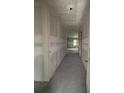 Spacious hallway with neutral walls leads to other rooms in this unfinished home at 1667 Meadowlark Dr, Deltona, FL 32725