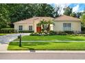 Charming single-story home featuring a well-manicured lawn and mature landscaping at 1679 Shadowmoss Cir, Lake Mary, FL 32746