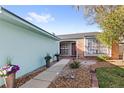 Inviting front entrance with a landscaped walkway and decorative potted plants at 17 Hibiscus Ct, Eustis, FL 32726