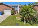 Exterior view of townhouse with manicured lawn, shrubbery, and an outdoor utility box at 17 Lawn St, Oviedo, FL 32765