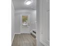 Bright entryway featuring wood-look flooring, a stairway, and a glass-paneled front door at 2026 Cypress Bay Blvd, Kissimmee, FL 34743