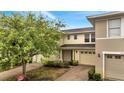 Charming townhouse with a brick-paved driveway and lush landscaping at 2026 Cypress Bay Blvd, Kissimmee, FL 34743