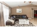 Comfortable living room featuring a sectional sofa, a stylish coffee table, and large windows with natural lighting at 216 Clara Vista St, Debary, FL 32713