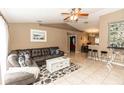 Inviting living room with tile floors, neutral decor, a cozy couch, and an open layout for entertaining at 216 Clara Vista St, Debary, FL 32713