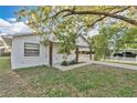 Well-maintained single-story home featuring a white brick facade and a convenient covered carport at 226 Noxon St, Auburndale, FL 33823
