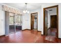 Cozy dining room with sliding glass doors to a screened porch and access to a laundry area at 2522 Junction Rd, Zellwood, FL 32798