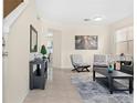 Bright living room featuring tile floors, modern decor, and a stylish seating area with lots of sunlight at 277 Sand Ridge Dr, Davenport, FL 33896