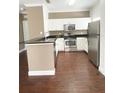 Modern kitchen with stainless steel appliances, white cabinets, and dark countertops at 2956 Lucayan Harbour Cir # 108, Kissimmee, FL 34746