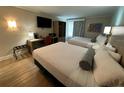 Inviting bedroom featuring two beds, a well-equipped desk area, and comfortable furnishings at 3000 Maingate Ln # 520, Kissimmee, FL 34747