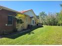 Lovely home featuring a brick exterior, palm tree, and a well-manicured lawn under a clear blue sky at 3150 Appaloosa Ct, Kissimmee, FL 34746
