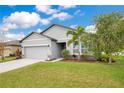 Charming single-Gathering home featuring a manicured lawn, two-car garage, and lovely landscaping at 3807 Night Heron Dr, Sanford, FL 32773