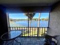 Relaxing balcony with seating and stunning views of the serene lake at 400 E Orlando Ave # 10 C, Ocoee, FL 34761