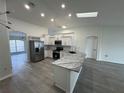 Bright kitchen with stainless steel appliances, granite countertops, and a large island at 403 Britten Dr, Kissimmee, FL 34758