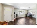 Spacious living room with dark wood floors, a large window, and a welcoming atmosphere at 4915 Pocahontas Ln, Lakeland, FL 33810