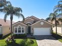 Inviting exterior with tile roof, a two-car garage, complemented by a well-kept lawn and mature palm trees at 631 Tuscan Hills Blvd, Davenport, FL 33897